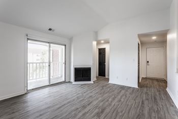 A spacious living room with a fireplace and sliding glass doors